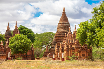 Buddhist pagoda temple. Bagan, Myanmar. Home of the largest and denset concentration of religion Buddhist temples, pagodas, stupas and ruins in the world. Blue sky with clouds.