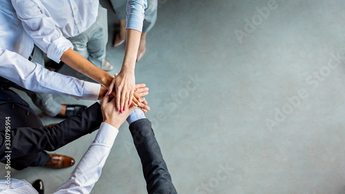 Cuadros en Lienzo Unrecognizable Business People Holding Hands Standing In Modern Office, Above-Vi