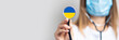 female doctor in a medical mask holds a stethoscope on a light background. Added flag of Ukraine. Concept medicine, level of medicine, virus, epidemic. Baner