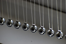 Business Concept For Strategy Team Work And Alignment. Newtons Cradle Pendulum.