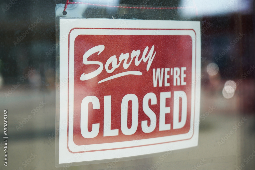Sorry we're closed sign behind dirty glass door during corona lockdown - obrazy, fototapety, plakaty 