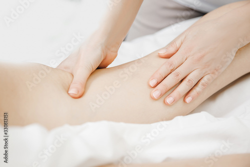 Anti varicose veins legs massage of young women beauty spa Poster Mural XXL