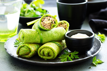 Canvas Print - Green pancakes with spinach, filling with liver and eggs. Selective focus