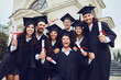 © Studio Romantic - A group of graduates smiling