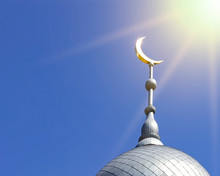 Mosque Of Muslim. Crescent On Copper Covered Dome And Minaret Of Mosque Against Blue Sky. Symbol Of Islam And Ramadan.