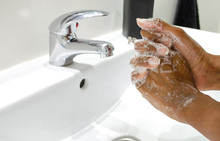 Black Woman Conscientiously Washing Her Hands With Soap. Selective Focus On Hands. Disinfection. Hygiene Concept.