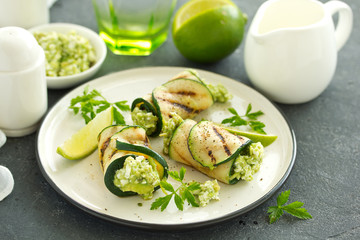 Canvas Print - Zucchini rolls stuffed with cottage cheese and avocado. Snack. Selective focus.