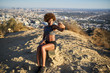 © Joshua Resnick - fit african american woman taking selfie at runyon canyon with los angeles in background