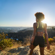© Joshua Resnick - fit african american woman hiking runyon canyon stopping to see view of sunset
