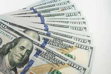 Stack of american money, one hundred dollar cash banknotes on white background, lot of one hundred dollar bills