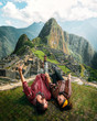  Watch this! Happy young tourist couple are on vacation, with ponchos in Machu Picchu