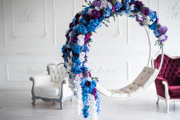 Beautiful decor of a swing of flowers, beautiful two armchairs for a photo.