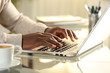 © PheelingsMedia - Black man hands typing on a laptop on a desk at home