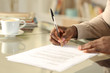 © PheelingsMedia - Black man hands singing contract on a desk
