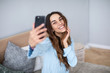 © BestForYou - Young woman taking selfie at home.