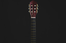 Guitar Fretboard On Black Background. Acoustic Musical Instrument