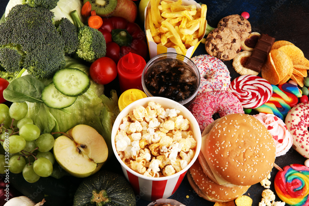 healthy or unhealthy food. Concept photo of healthy and unhealthy food. Fruits and vegetables vs donuts,sweets and burgers - obrazy, fototapety, plakaty 