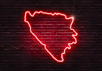 Wall Mural - Neon sign on a brick wall in the shape of Bosnia and Herzegovina.(illustration series)