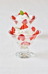 Canvas Print - cheese cream. whipped curd cream with strawberries. Homemade cottage cheese is whipped with cream. Chamomile flowers. A useful dessert. On a light background.