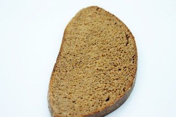 A piece of black rye bread smelted on a white background