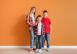 © Pixel-Shot - Portrait of happy family near color wall