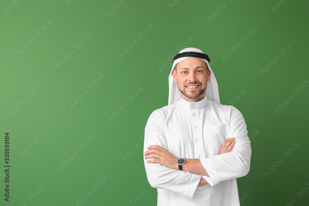 Handsome Arab man on color background