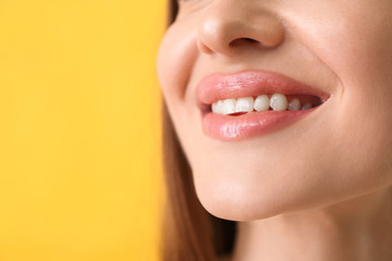 Wall Mural - Young woman with beautiful smile on color background, closeup