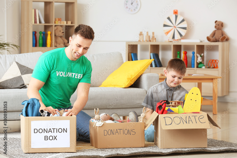 Volunteer with donations and little boy at orphan home