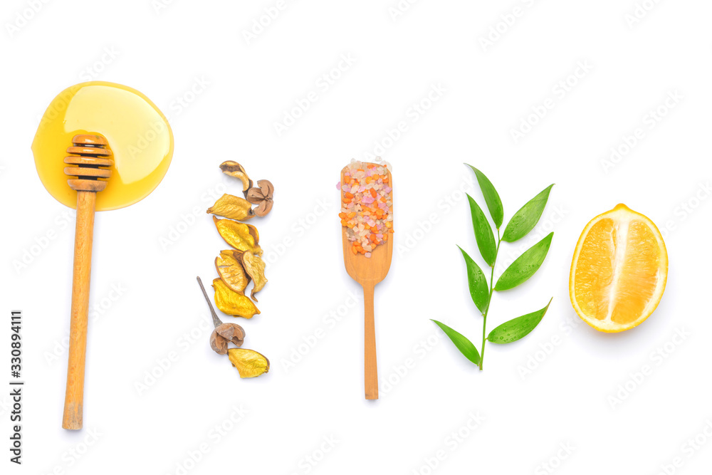 Composition with honey, sea salt and lemon on white background