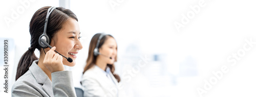 Fotomural Banner of smiling telemarketing Asian woman working in call center office