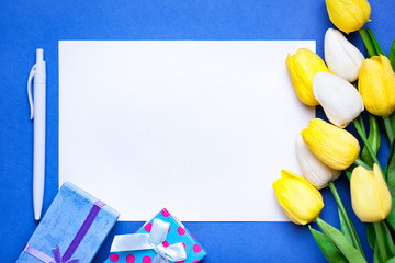 Wall Mural - bouquet of spring tulips on a bright background. greeting card. space for text.