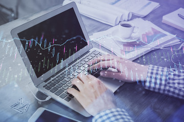 Double exposure of forex graph with man working on computer on background. Concept of market analysis.