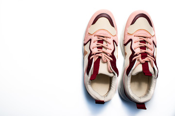 pair of running shoes on white background. red and white sneakers for keeping healthy. space for tex