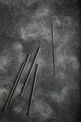 Wall Mural - iron cocktail straws on dark moody black with grey concrete texture or background. with place for te