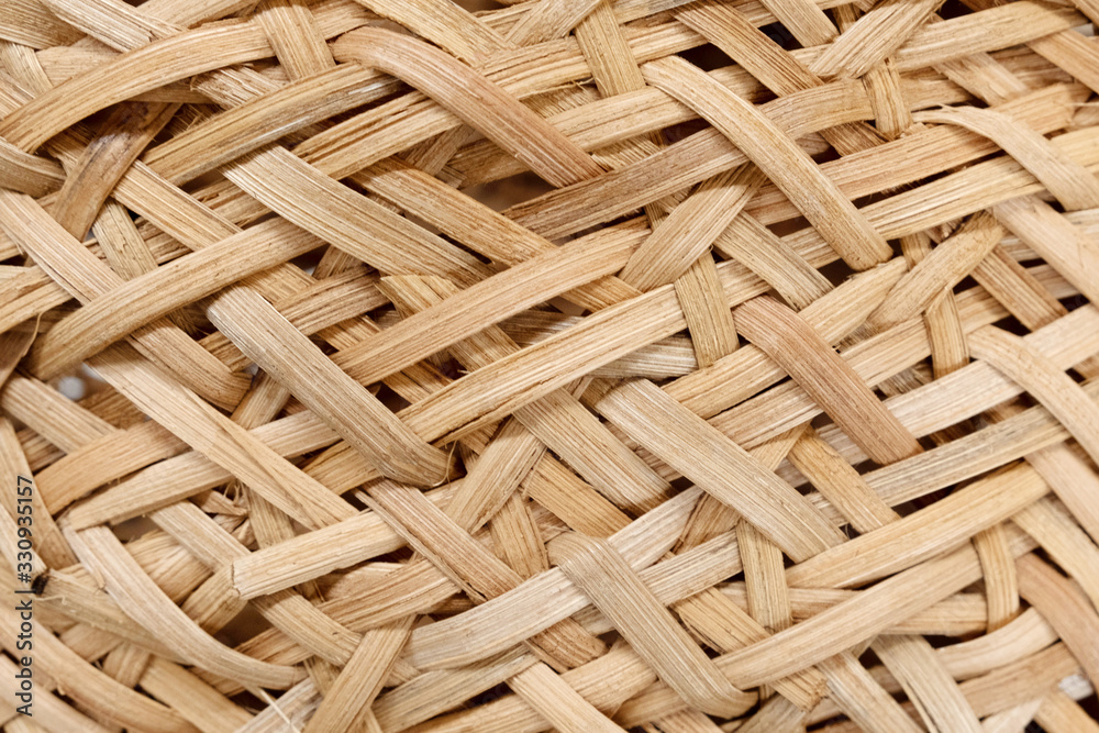 Closeup texture of wicker basket in beige color. Natural materials in the industry. No waste. Recycling. Background and texture. - obrazy, fototapety, plakaty 
