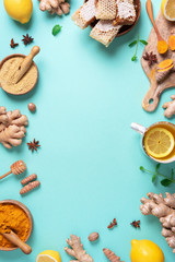 Wall Mural - Medical care concept. Cold, flu treatment. Ginger, lemon, honey, pills, drugs, supplements, thermometer on blue background. Natural alternative holistic approach. Top view, copy space