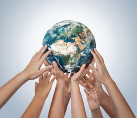 Wall Mural - many children hands holding planet earth isolated on blue background with copy space