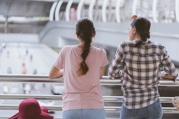 Two Young Asian women are Worried Virus outbreak or about the weather and pollution in the capital Since there no health, life protection equipment. City air pollution affects health, tourism concept