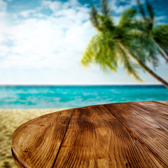 Wall Mural - wooden desk of free space and summer beach background with green palms