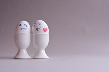 Faces on eggs, happy relationship in the minimalism of the cartoon. Creative easter. Free space for text. Copy space