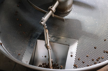 Empty Coffee Roaster Drum With A Few Beans.