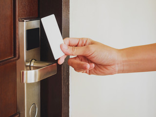 Hand Holding Key card Hotel door room access Security system