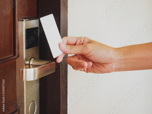 Hand Holding Key card Hotel door room access Security system