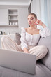 © ZoomTeam - coronavirus epdemic. , woman looking at laptop while at home in office work space .