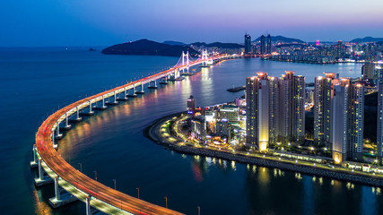 Poster - Aerial view Busan Gwangan Daegyo Bridge or Gwangan Bridge skyline and skyscraper building architecture illuminated in the night. Busan, South Korea..