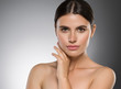 © Utkamandarinka - Beauty woman healthy skin care hand touching face clean skin beautiful eyes gray background