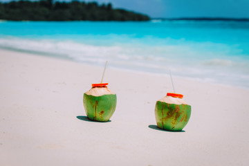 Wall Mural - two coconut drinks on tropical beach vacation