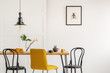 © Photographee.eu - Stylish yellow chair at wooden dining table in trendy interior