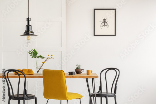 Fotomural Stylish yellow chair at wooden dining table in trendy interior