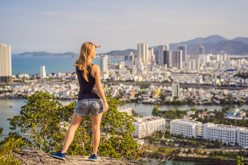 Wall Mural - Woman tourist on the background of Nha Trang city. Travel to Vietnam Concept